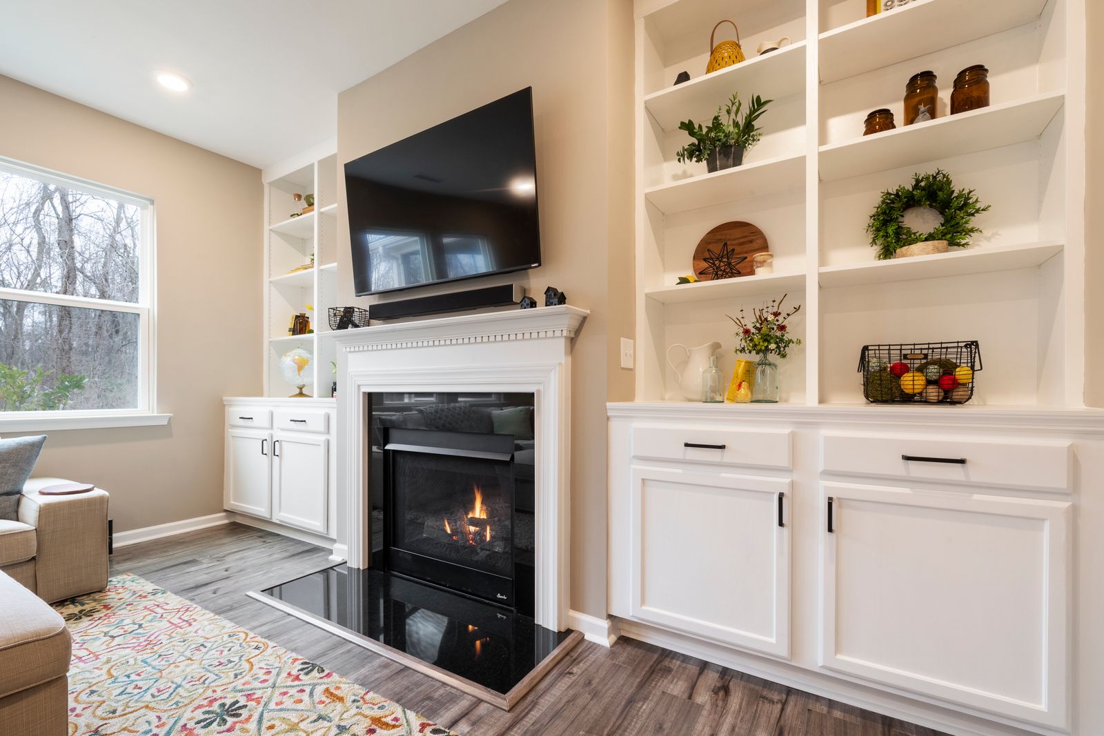 Custom white built-in cabinetry around a fireplace