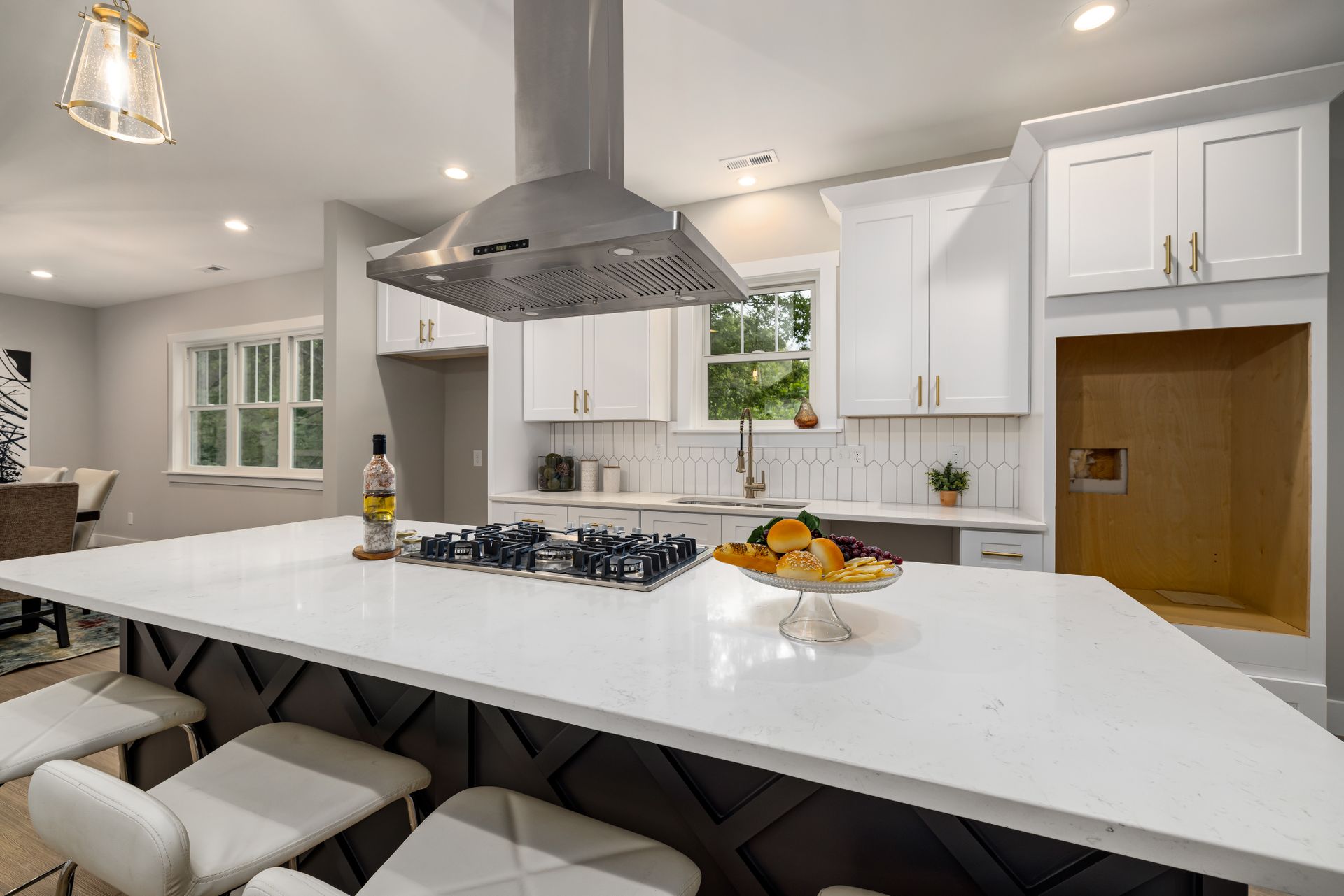 Bright modern kitchen with waterfall island and quartz counters
