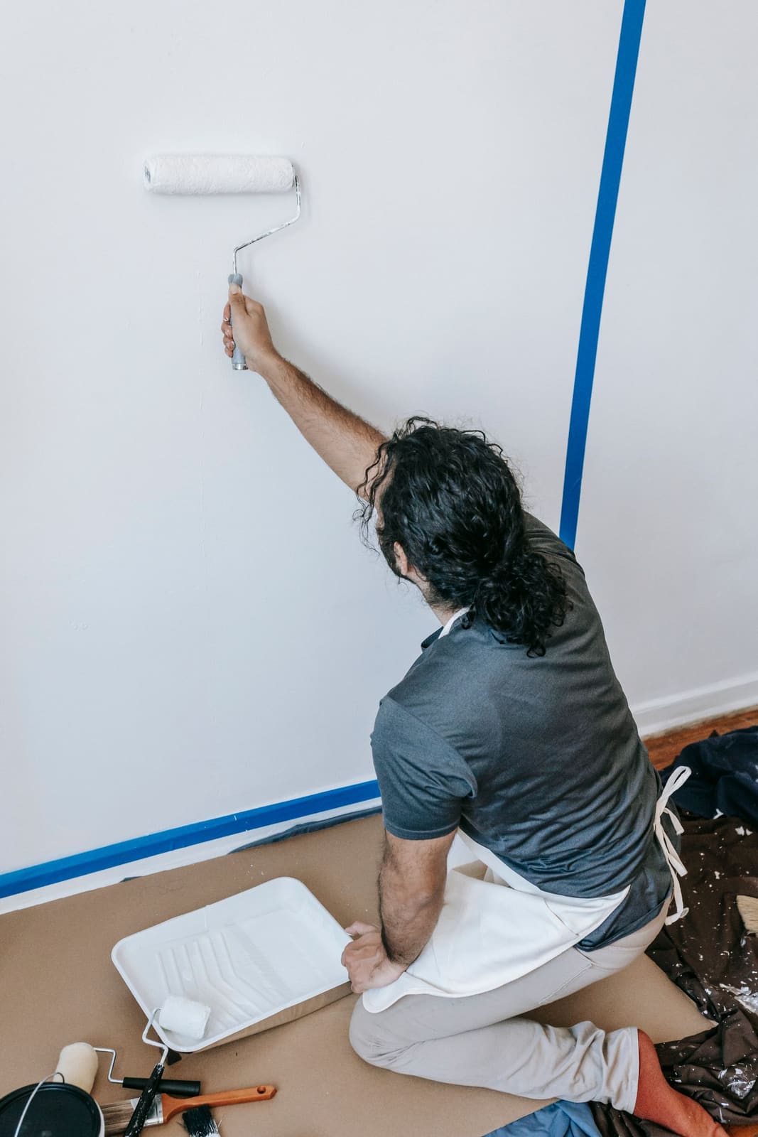 Painting — Freshly painted bright interior room, crisp trim and edges, roller/brush detail.